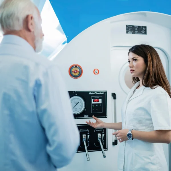 young doctor senior man standing front hyperbaric chamber talking about oxygen therapy 11zon 11zon 1 noormedicalgroup